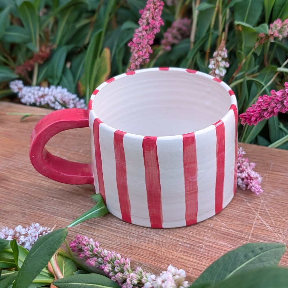 Handled mug with hand-painted red stripes and a red handle
